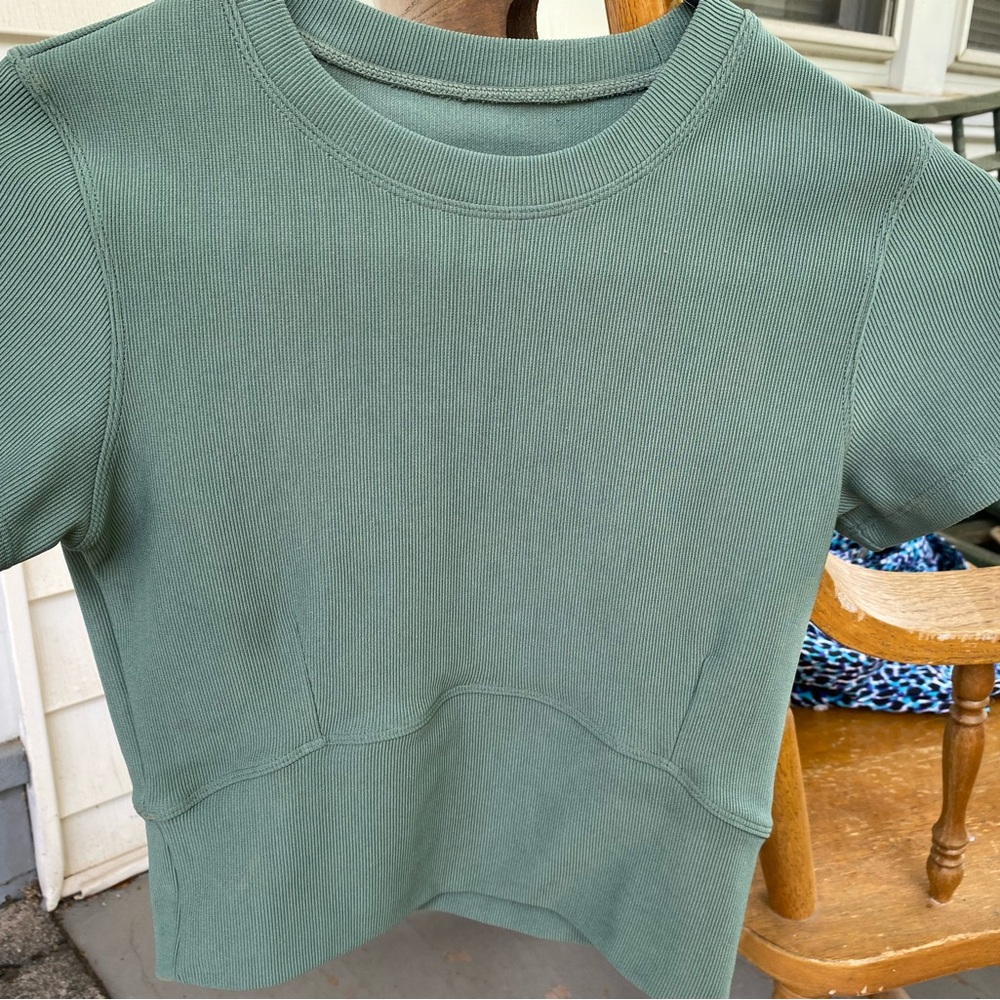 Move Theology sage green fitted chop top with front darts and wide waist band